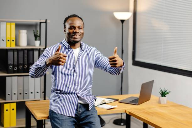 istock Man giving thumbs up in office 2080876587
