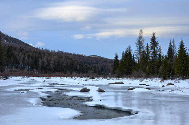 istock Icy river in a winter wonderland under a cloudy sky 2080902605
