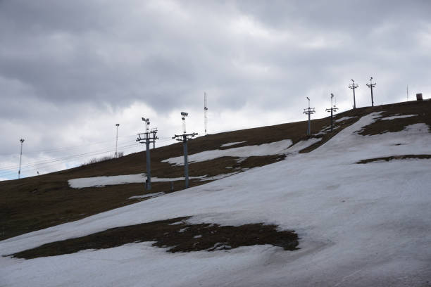 Upper terminal of chairlift with the return bullwheel on hilly landscape covered by rocks, at the Serra da Estrela. The highest mountain range in continental Portugal, with astonishing scenery.