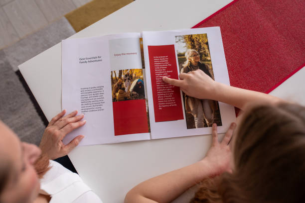 istock Mother reading a magazine with her daughter at home 2080909433