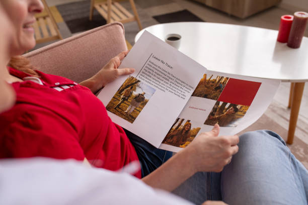 istock Two women reading a magazine at home 2080911675