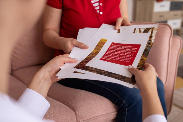 istock Two women reading a magazine at home 2080912093