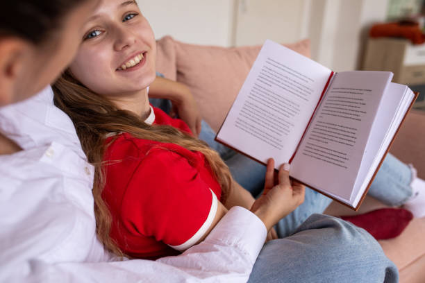 istock Mother and daughter reading a book together 2080913180