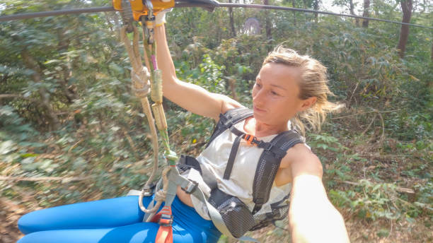 istock Jungle Flight: A Young Woman's Adventure Zip-Lining in Laos 2080913181