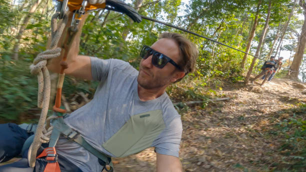 istock Adventurous male takes a selfie while zip lining over a tropical rainforest 2080913184