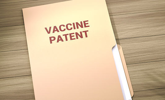 Vaccine Patent File Folder On Wood Table