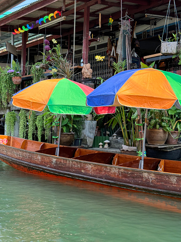 Stock photo showing Damnoen Saduak floating market, Ratchaburi, Thailand on Khlong Damnoen Saduak a canal link to Tha Chin and Mae Klong rivers. This is a popular market and is very touristy.