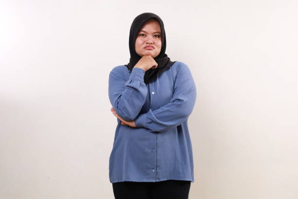 istock Unhappy sad asian muslim woman standing while looking at the camera 2080929151