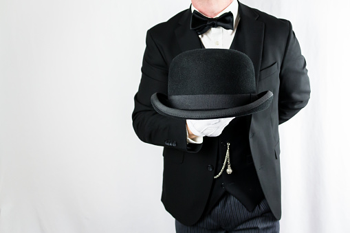 Butler or Hotel Concierge Holding Bowler Hat