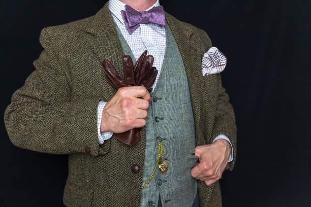 istock Gentleman in Tweed Suit Holding Leather Gloves 2080940447