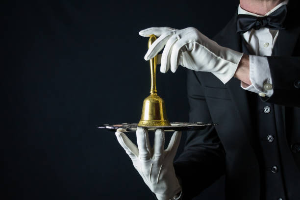 istock Ring for Service Butler Holding Bell 2080940990