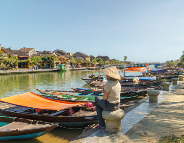 istock Tourist woman sitting wearing typical Vietnamese hat 2080942148