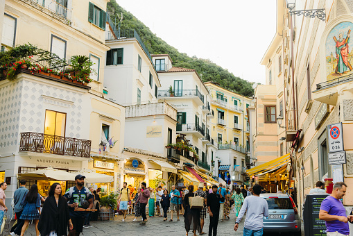 September 24, 2024: Walking the old streets with traditional cliffside buildings during summer season in Amalfi, Naples region, South Italy