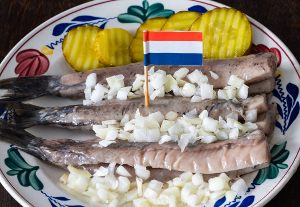Typical dutch food, raw herring with pickles and onion, known locally as Hollandse Nieuwe