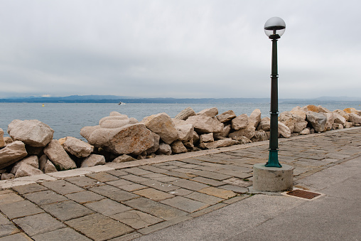 Bollard in front of the cemetery of Venice (Italy) on a sunny day in winter