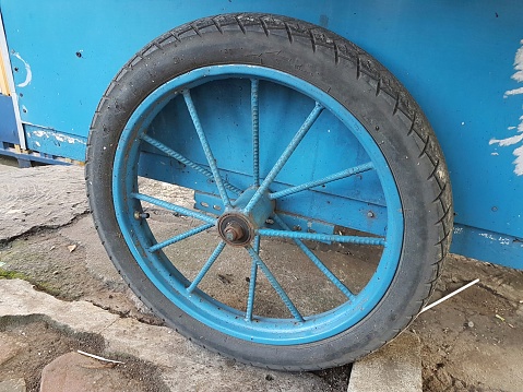 A wagon wheel with faded blue spokes