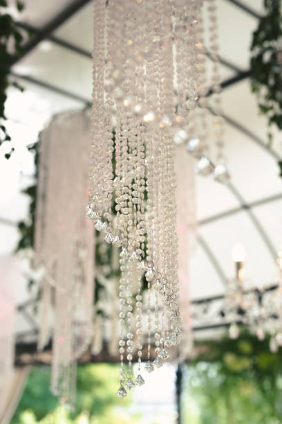 istock Beautiful luxurious romantic decor for a wedding celebration. The arch is decorated with draped fabric and a crystal chandelier. 2080973024