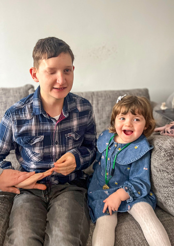 Partially blind man celebrating birthday with toddler