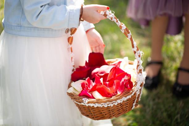 Children with a basket throwing rose petals at a wedding.