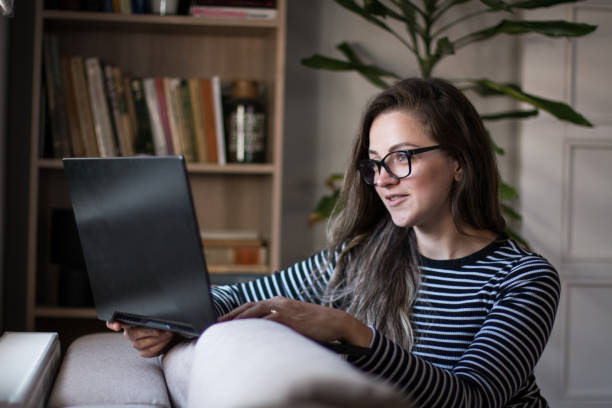 istock Young female freelancer working from home on her laptop computer. 2081027845