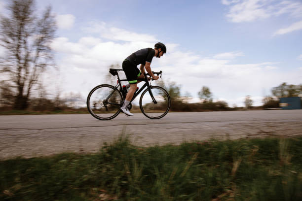 Bicycle rider sprinting on road bike