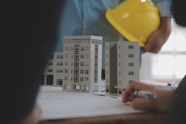 istock Construction and structure concept of Engineer or architect meeting for project working with partner and engineering tools on model building and blueprint in working site, contract for both companies. 2081034378