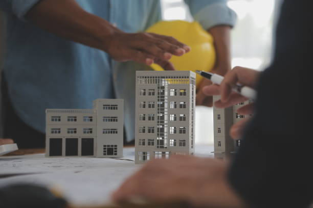 istock Construction and structure concept of Engineer or architect meeting for project working with partner and engineering tools on model building and blueprint in working site, contract for both companies. 2081036466