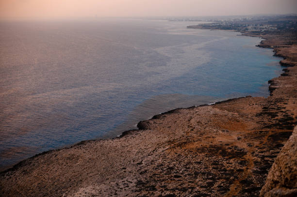 Evening time over dark blue mediterranean, rocks and nature of Cyprus. Peaceful relaxation in Ayia Napa during summer time.