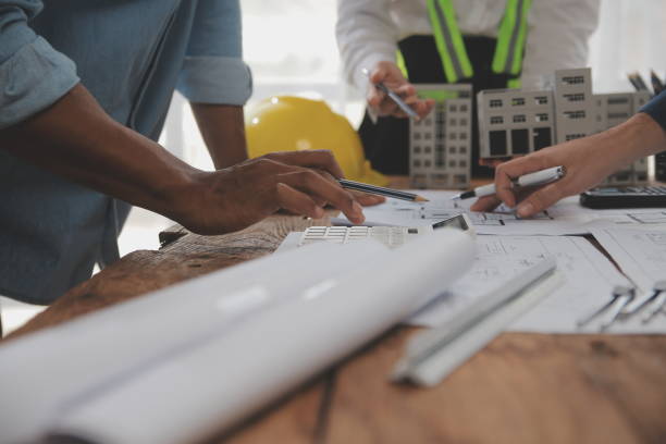 istock Construction and structure concept of Engineer or architect meeting for project working with partner and engineering tools on model building and blueprint in working site, contract for both companies. 2081043313