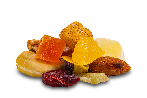 Closeup view pile of mix fruit and nuts isolated on white background with clipping path.