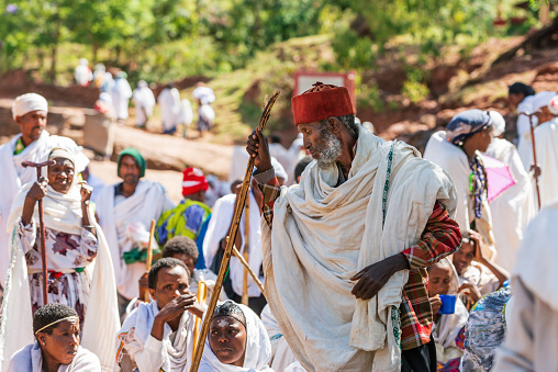 Lalibela, Ethiopia - May 1, 2019: Orthodox Ethiopians unwind at St. George Church after Mass. A serene moment capturing faith and cultural richness.
