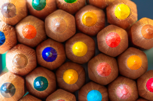 Color image depicting a close up macro abstract view of a collection of colored pencils.
