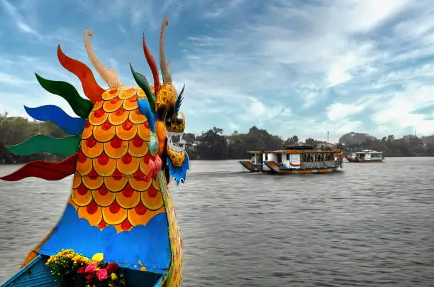 Dragon-boat tour at Huong River, known as the Perfume River. In the autumn, flowers from orchards fall into the water, giving the river a perfume-like aroma, Hue, Vietnam