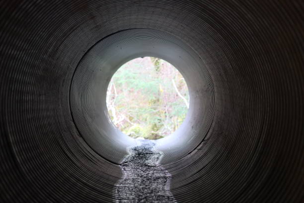 istock View through a round tunnel carrying a stream beneath a road 2081115997