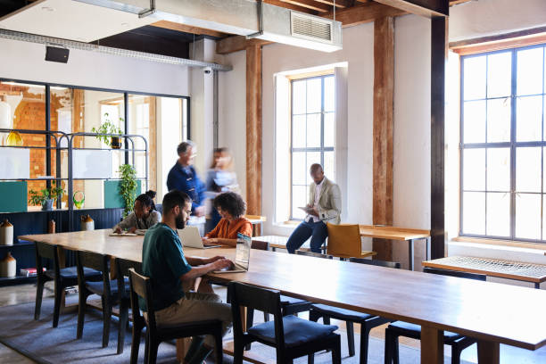 Group of diverse businesspeople working in a busy open plan office space