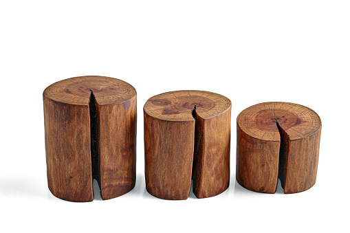 Three sawed tree trunks with a crack isolated on a white background. Podiums for product advertising of different heights.