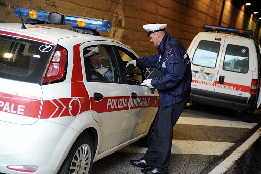 Italian Municipal Police with their patrols and cars direct traffic in the city, intervene in traffic accidents, and issue fines and penalties to motorists who do not obey traffic laws.