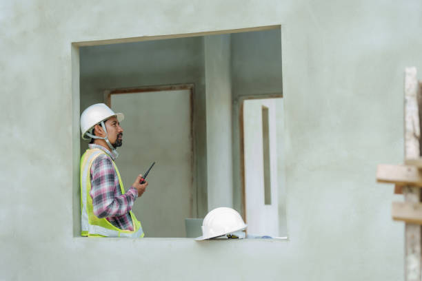 istock Male construction engineer, safety helmet, carrying radio device for communicating with technicians within construction zone, In order make coordination call that is not complicated. 2081165831