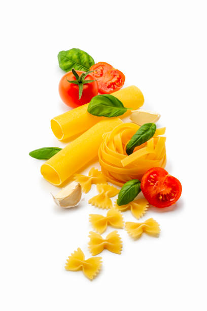Top view of ingredients for cooking traditional Italian pasta shot, isolated on white background. Studio shot.