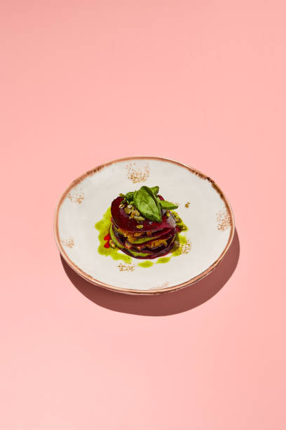 istock Beetroot mille-feuille with pesto sauce on a chic plate against a coral pink backdrop, a delight for gourmet vegetarian cuisine 2081195448