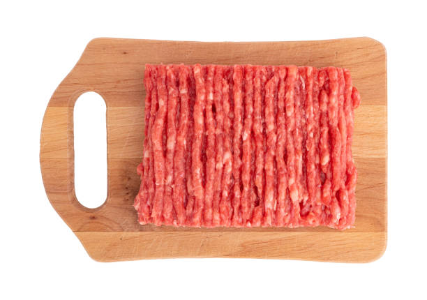 raw fresh minced meat on wooden board isolated on white background with clipping path, raw beef mince top view, meat of pork or chicken ready to cook lasagna or meatballs