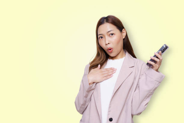 Young asian woman singing with microphone, isolated on white background.