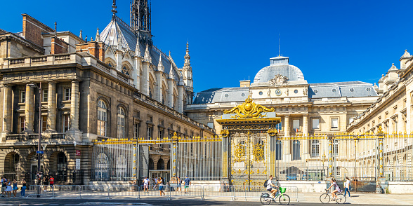 Paris, France - September 10, 2023 : Entrance of Paris courthouse and Sainte-Chapelle church on sunny day