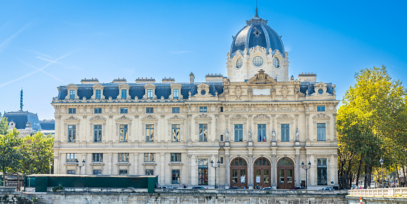 Paris, France - September 10, 2023 : Front facade of the Commercial Court building along the Seine river in Paris, France
