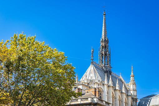 Paris, France - September 10, 2023 : Apse and spire of the Sainte-Chapelle church on sunny day