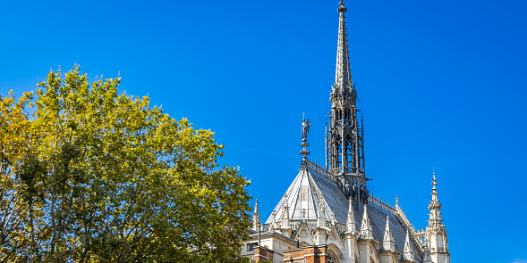 Spire of the Sainte-Chapelle church on sunny day in Paris, France