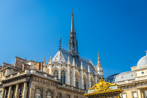 Apse and spire of the Sainte-Chapelle church on sunny day in Paris, France