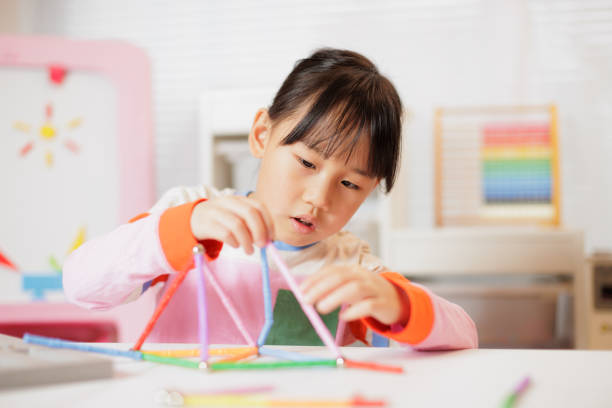 istock young girl playing Construction toys at home 2081222980