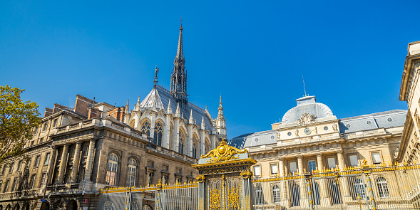 Paris, France - September 10, 2023 : Exterior view of Paris courthouse and Sainte-Chapelle church on sunny day
