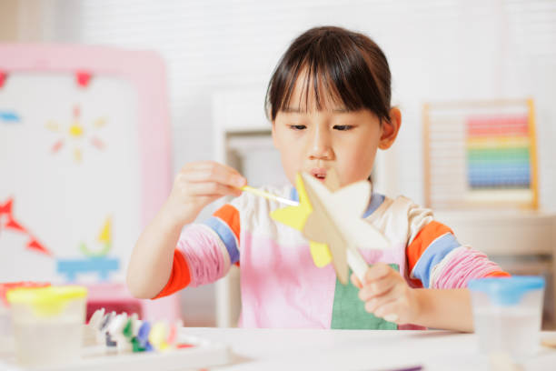 istock young girl making craft at home 2081224120